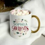 Personalised 'Believes' Gold Handled Ceramic Christmas Mug