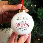 Personalised 'Believes' Holly Design Ceramic Christmas Bauble - Image 2
